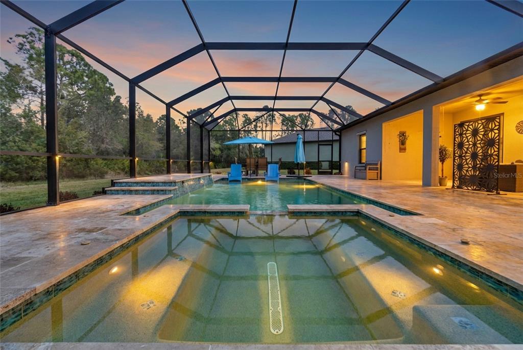 A paved walkway leads to the covered front porch of a house with stone accents — 2607 162ND PLACE E, PARRISH, FL