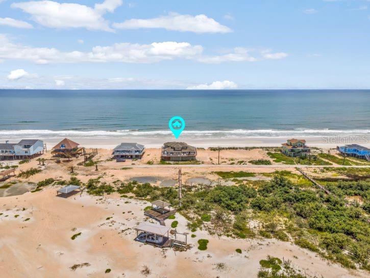 An aerial view of a beachfront house with a blue location pin on the coast — 9353 OLD A1A, ST AUGUSTINE, FL