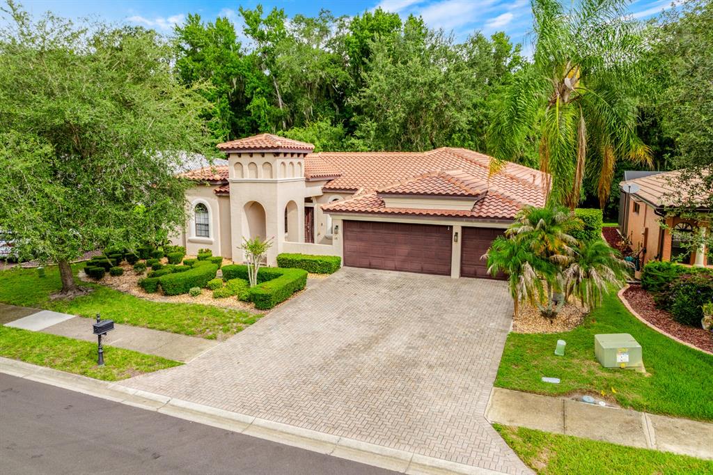 A single-story house with a tile roof, a two-car garage, and a landscaped front yard — 148 VERDE WAY, DEBARY, FL