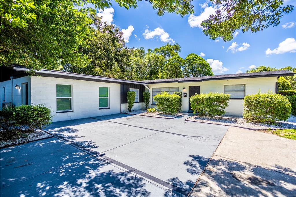 A single-story white house with a flat roof and a paved front driveway — 1213 CORBETT LANE UNIT 2, ORLANDO, FL