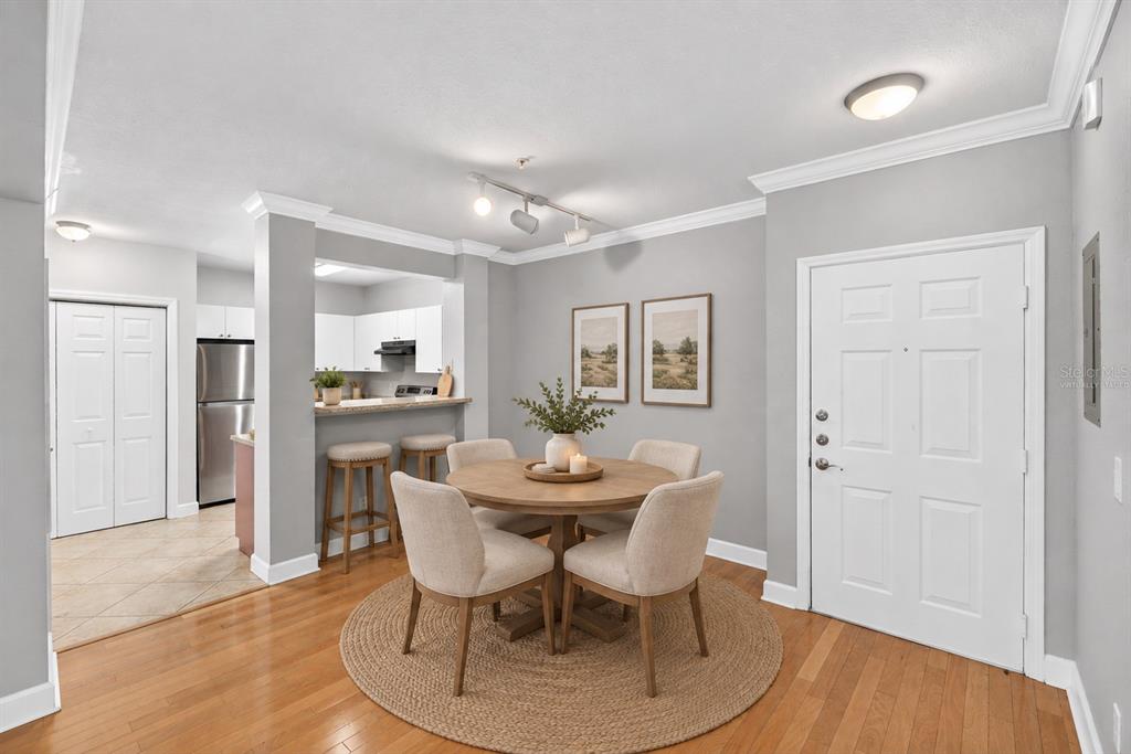 A kitchen features red lower cabinets, white upper cabinets, gray countertops, and tile flooring — 300 E SOUTH STREET UNIT 2014, ORLANDO, FL
