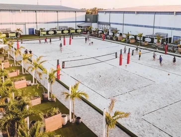 An outdoor sand volleyball court complex features multiple nets and surrounding palm trees — 6... K PARKWAY, ORLANDO, FL