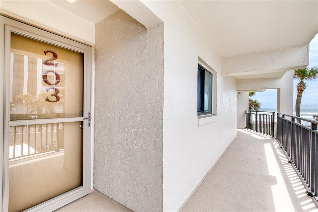 A view of a building exterior hallway with a numbered door and ocean views — 1275 OCEAN SHORE BOULEVARD UNIT 2030, ORMOND BEACH, FL