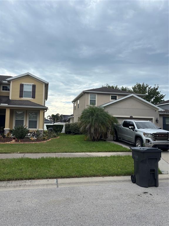 Two suburban houses with lawns, a silver pickup truck, and a trash bin — 12226 FAIRLAWN DRIVE, RIVERVIEW, FL