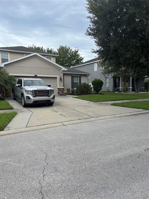 A silver pickup truck is parked in the driveway of a suburban two-story house — 12226 FAIRLAWN DRIVE, RIVERVIEW, FL
