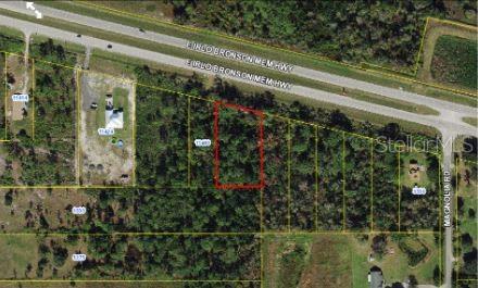 This aerial map shows a rectangular plot of land highlighted in red near a highway — E IRLO BRONSON MEMORIAL HIGHWAY, ST CLOUD, FL