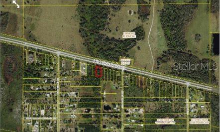 This is an aerial map showing a highlighted rectangular land parcel along a highway — E IRLO BRONSON MEMORIAL HIGHWAY, ST CLOUD, FL