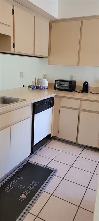 A kitchen features beige cabinets, white appliances, a tiled floor, and a black floor mat — 2218 ABBEY ROAD, WINTER HAVEN, FL