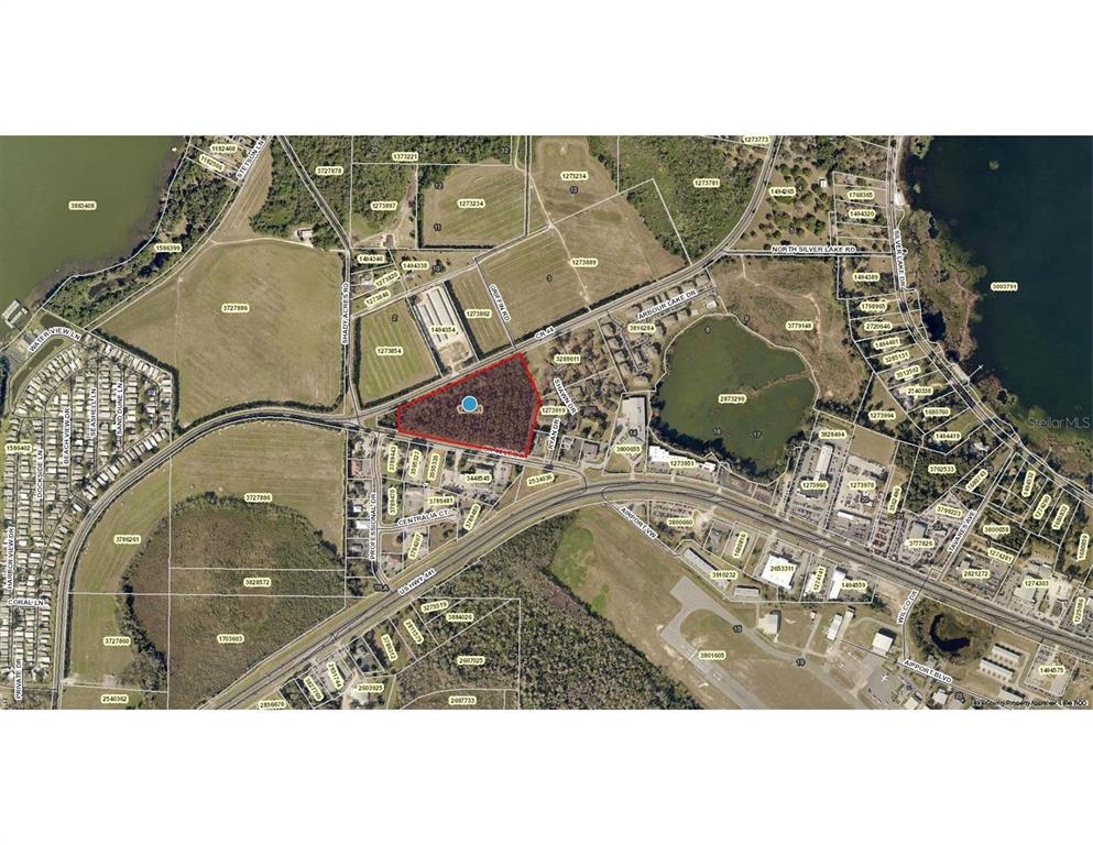 This is an aerial map showing a highlighted parcel of land surrounded by roads and buildings — COUNTY ROAD 44, LEESBURG, FL