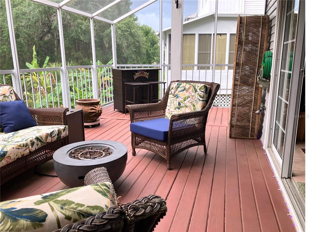 A living room features a brown leather sofa, a beige sofa, and a dark ottoman — 2015 VISTA DEL SOL CIRCLE UNIT 108, LUTZ, FL