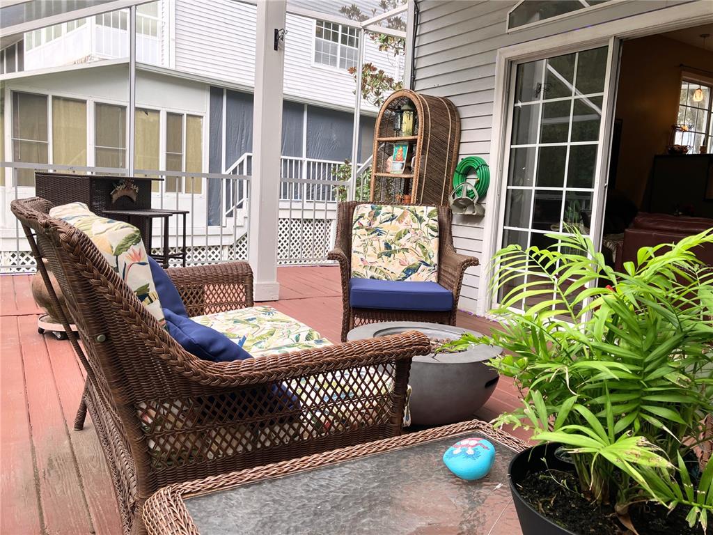 A dining area with a wooden table and chairs sits next to a kitchen island — 2015 VISTA DEL SOL CIRCLE UNIT 108, LUTZ, FL