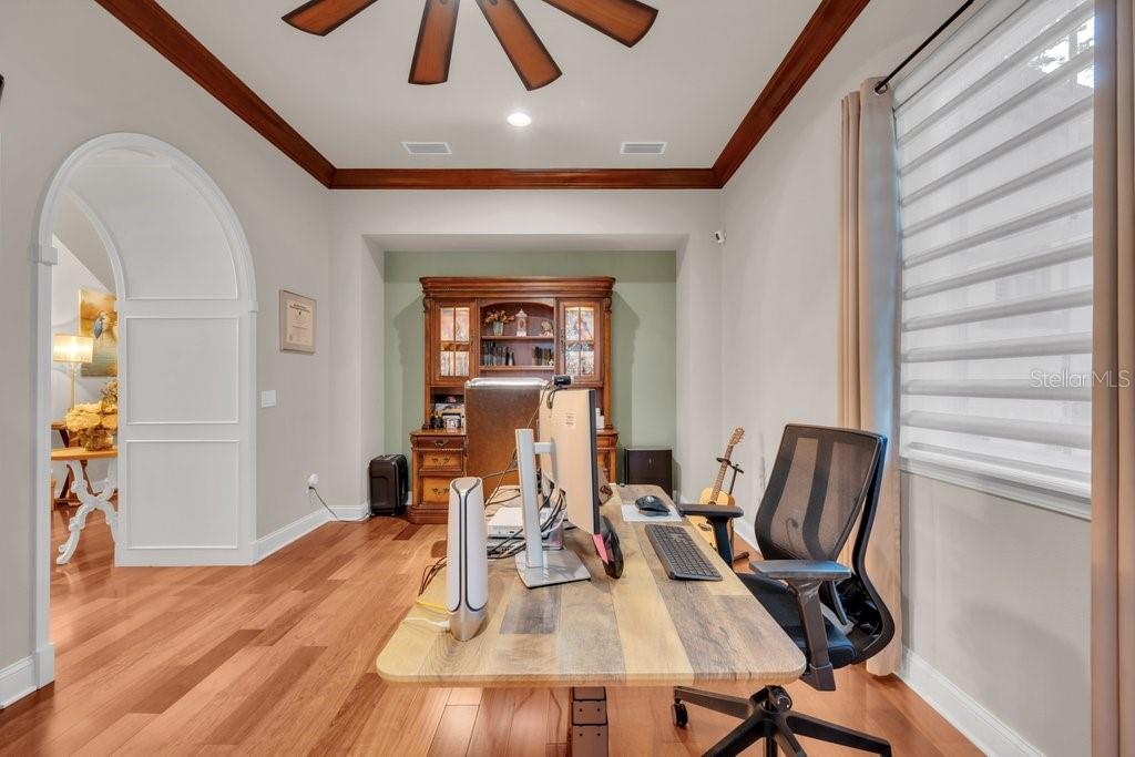 A home office features a wooden desk, a rolling chair, and a large hutch — 16012 TERNGLADE DRIVE, LITHIA, FL