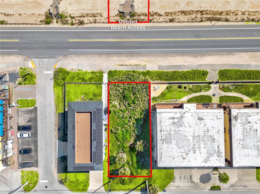 An aerial view shows a rectangular vacant lot situated between two buildings near a road — 21XX N OCEAN SHORE BOULEVARD, FLAGLER BEACH, FL