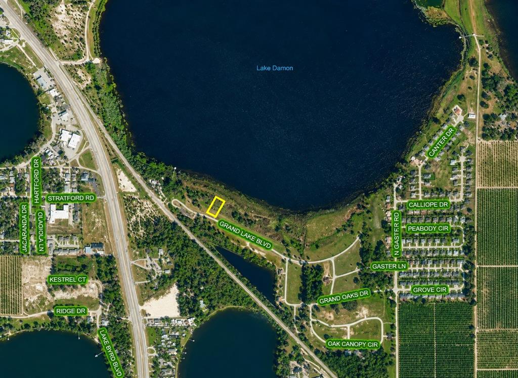 An aerial view shows a swimming pool, a covered patio, and a wooden dock on a lake — 998 GRAND LAKE BOULEVARD, AVON PARK, FL