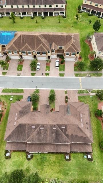 A kitchen features wood cabinets, granite countertops, and stainless steel appliances — 1743 PORTOFINO MEADOWS BOULEVARD, ORLANDO, FL