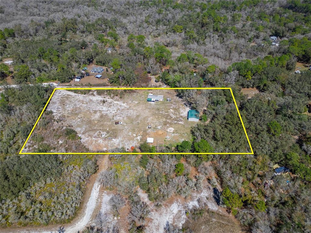 An aerial view shows a rectangular lot with a house and shed surrounded by trees — 35238 MANUEL STREET, WEBSTER, FL