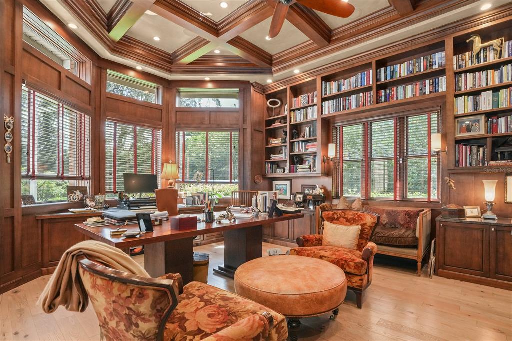 A wood-paneled home office features a coffered ceiling, built-in bookshelves, and floral armchairs — 16211 VILLARREAL DE AVILA, TAMPA, FL