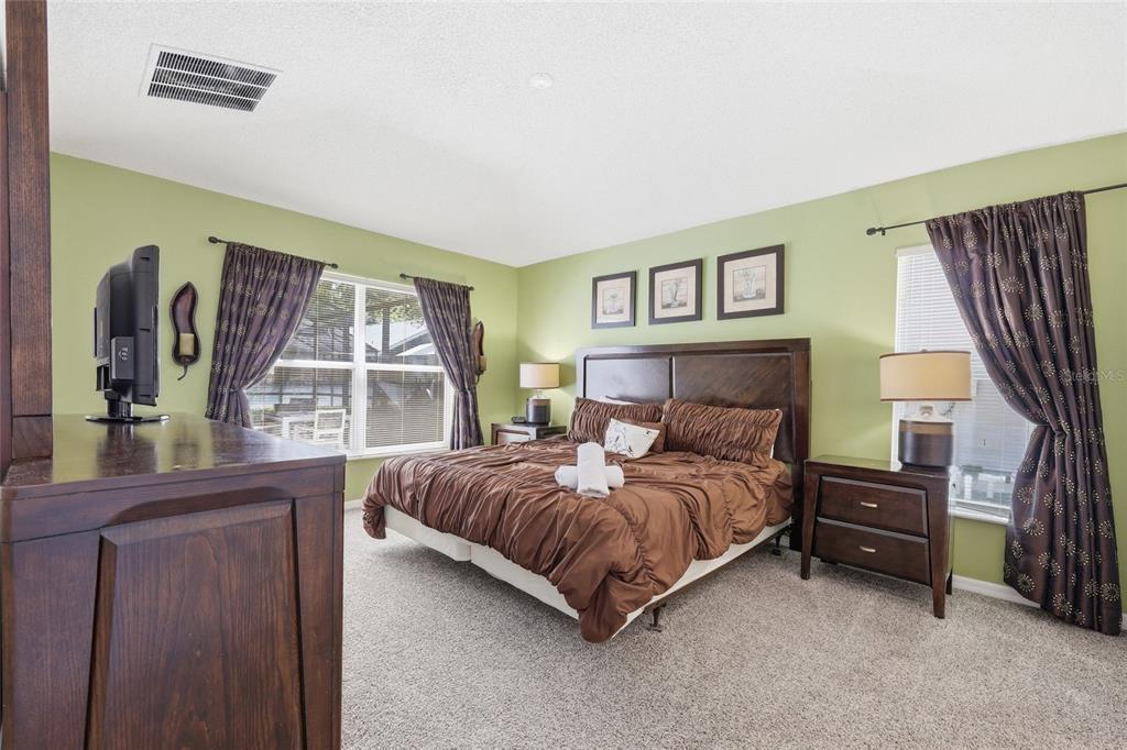 A single-story house with a green exterior, a two-car garage, and an arched entryway — 2721 LIDO KEY DRIVE, KISSIMMEE, FL