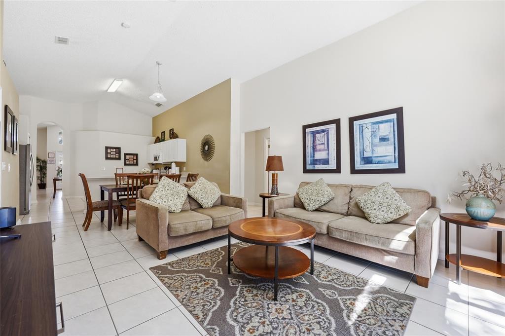 A single-story house with a two-car garage, arched entryway, and a palm tree in front — 2721 LIDO KEY DRIVE, KISSIMMEE, FL