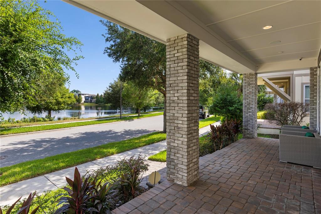 A backyard features a rectangular pool and spa surrounded by brick pavers at dusk — 13041 GABOR AVENUE, ORLANDO, FL