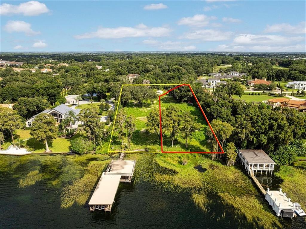 An aerial view shows two adjacent waterfront lots with docks extending into a lake — 12418 PARK AVENUE, WINDERMERE, FL