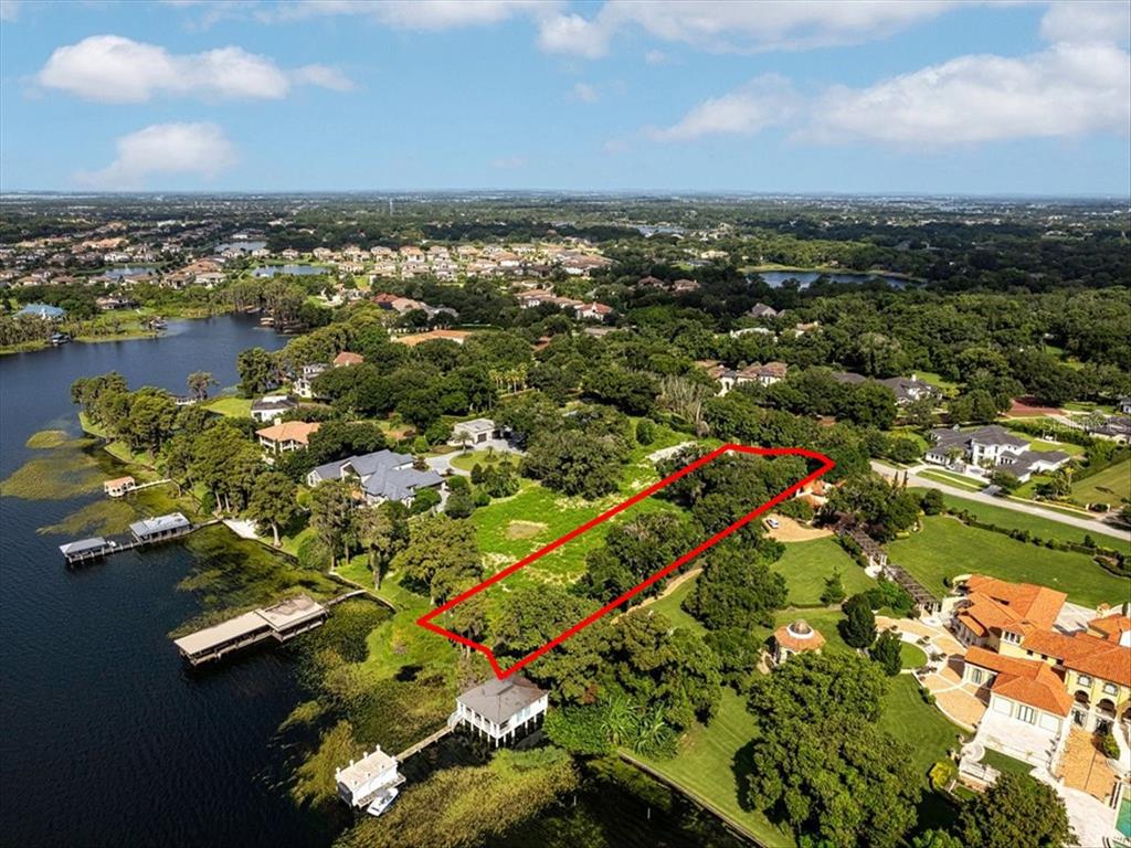 An aerial view shows a rectangular plot of land outlined in red near a lake — 12418 PARK AVENUE, WINDERMERE, FL