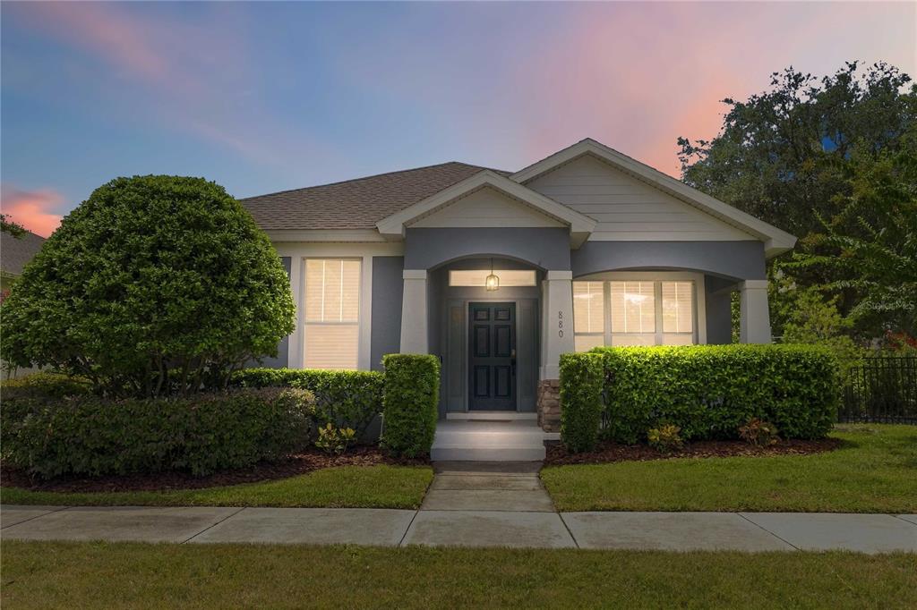 A single-story house with a gray exterior, a covered entryway, and manicured hedges in front — 880 SUMMER OAKS ROAD, WINTER GARDEN, FL