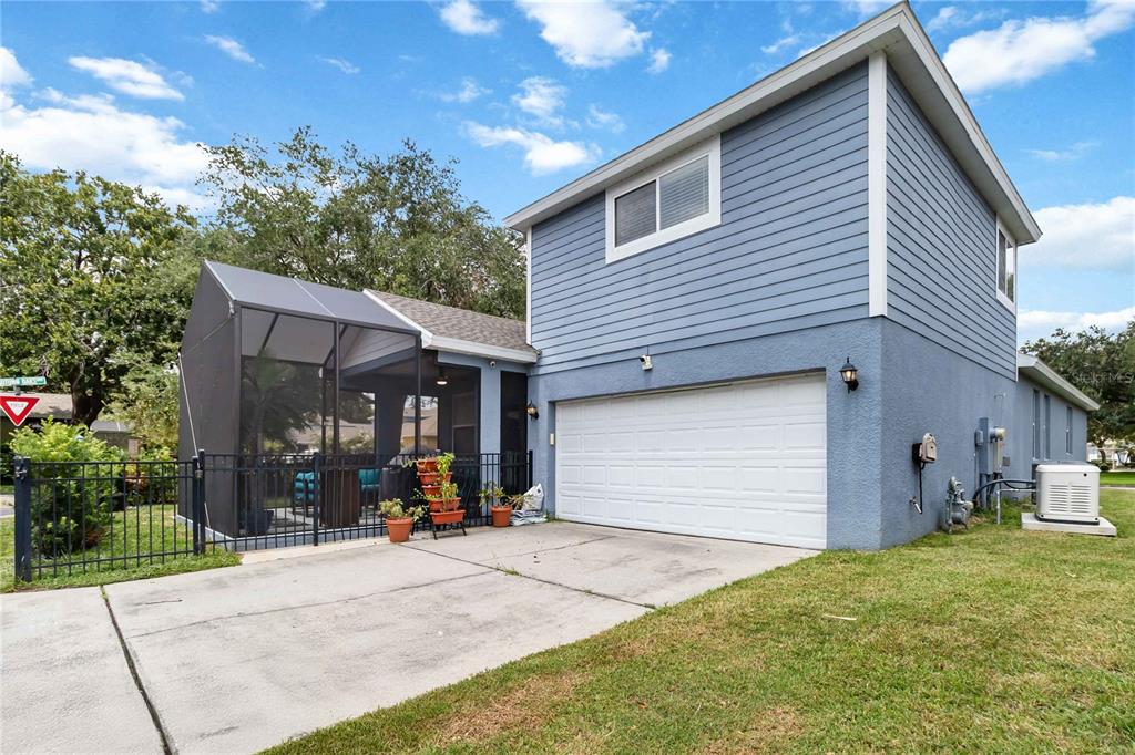 A two-story blue house with a white garage door and an attached screened-in patio — 880 SUMMER OAKS ROAD, WINTER GARDEN, FL