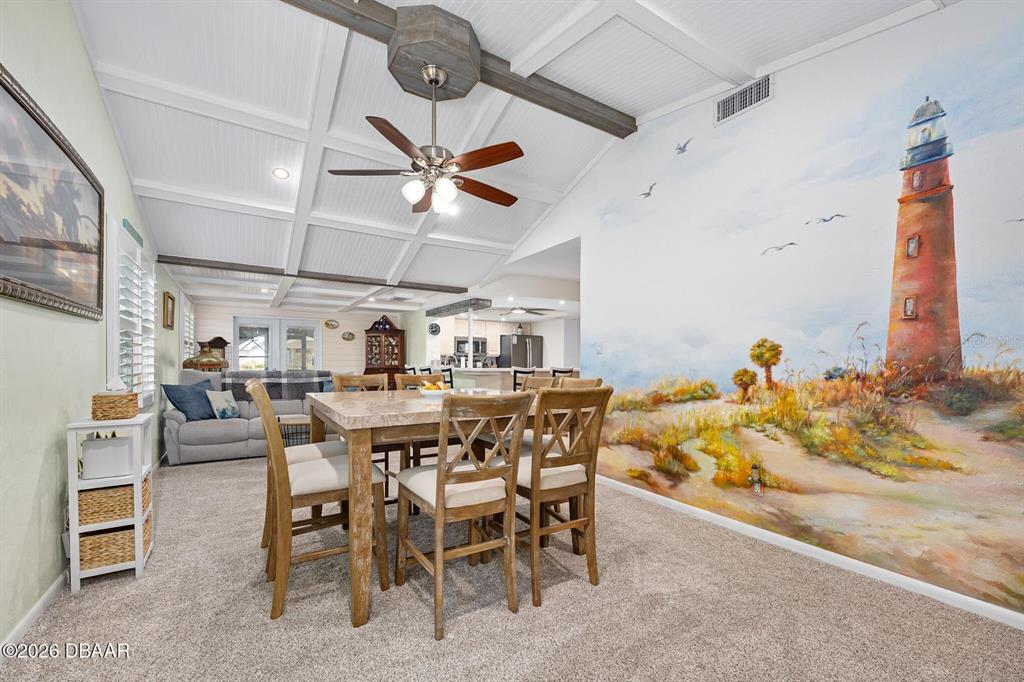 A dining area features a large lighthouse mural, a coffered ceiling, and a ceiling fan — 4708 DIXIE DRIVE, PONCE INLET, FL