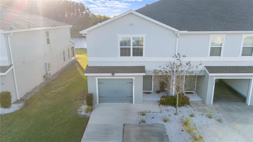 An aerial view of a two-story townhouse with a garage and a small front yard — 2922 FIELDWOOD CIRCLE, ST CLOUD, FL