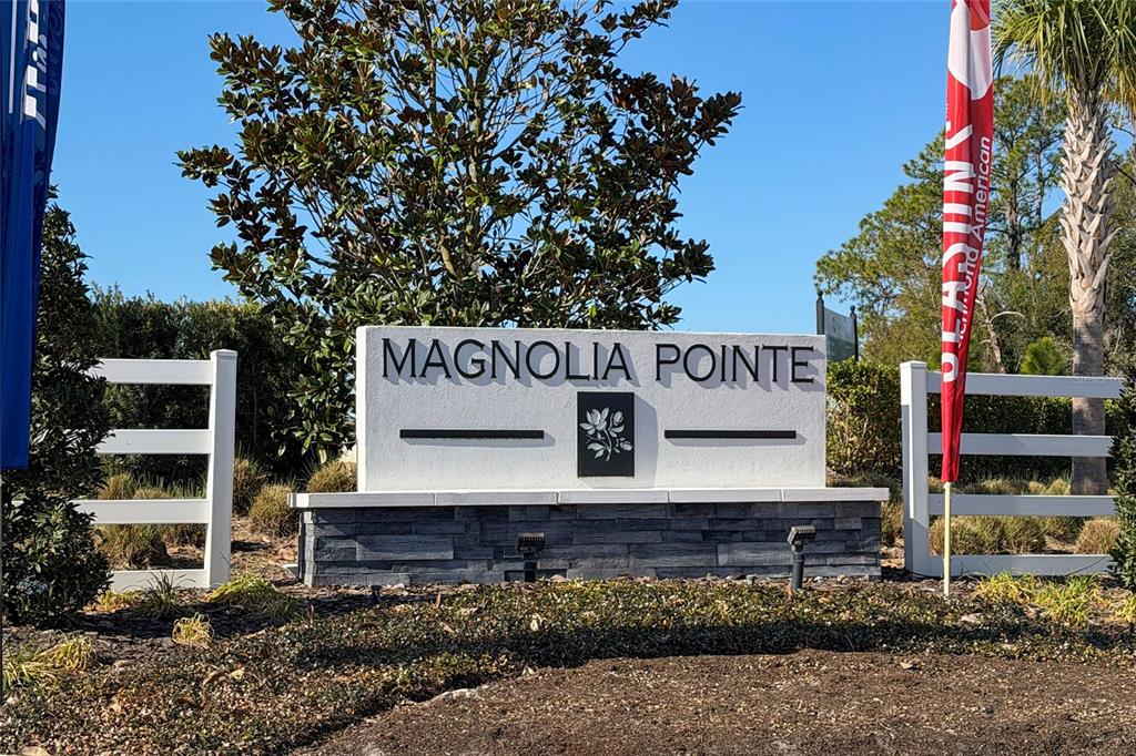 A white monument sign for Magnolia Pointe stands in front of a tree and fence — 955 BEAR HAMMOCK DRIVE, UMATILLA, FL