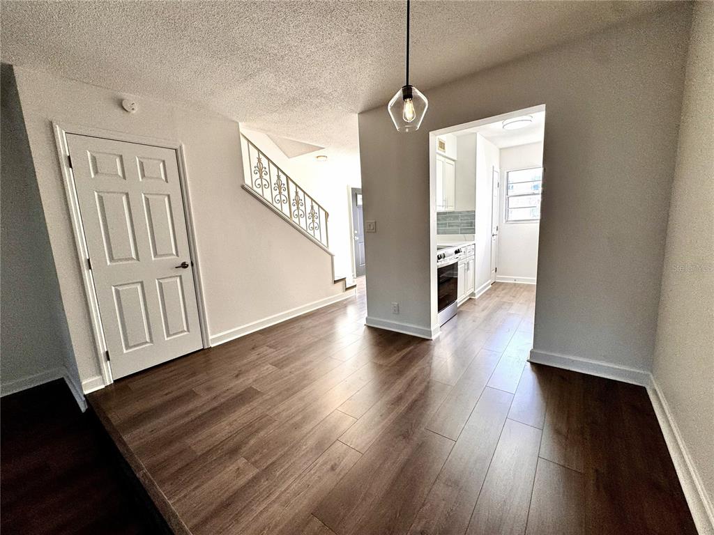 A bathroom features a white toilet next to a bathtub with a handheld shower head — 1134 RUE DES ROIS UNIT 1134, ST PETERSBURG, FL