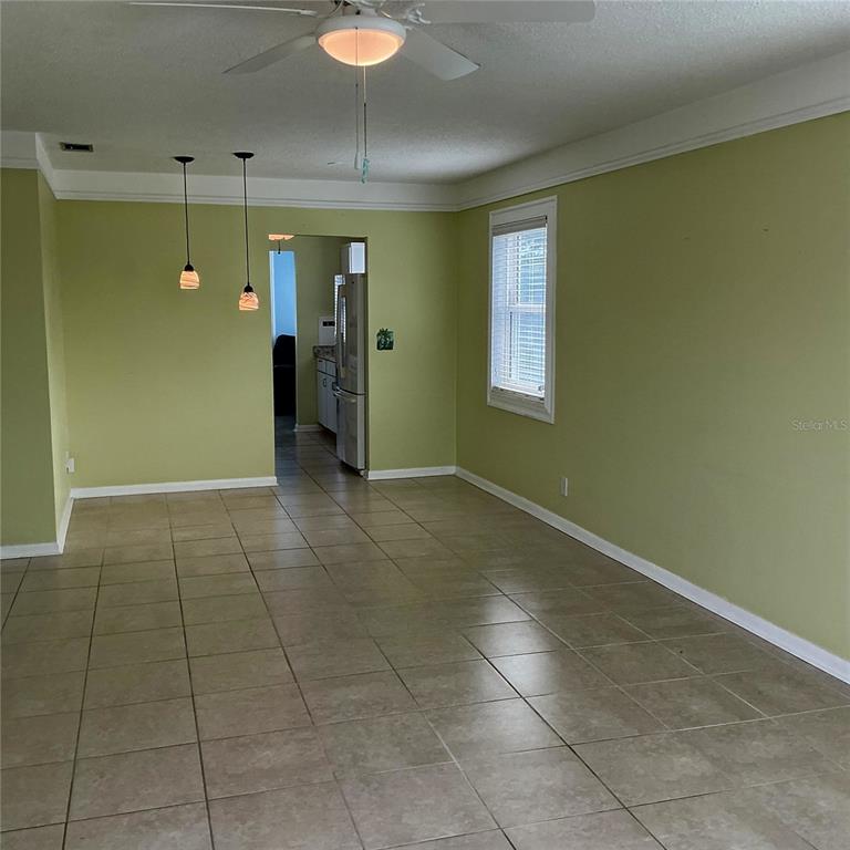An exterior view of a balcony featuring a green door marked with the number 26 — 5267 81ST ST N UNIT 26, ST PETERSBURG, FL