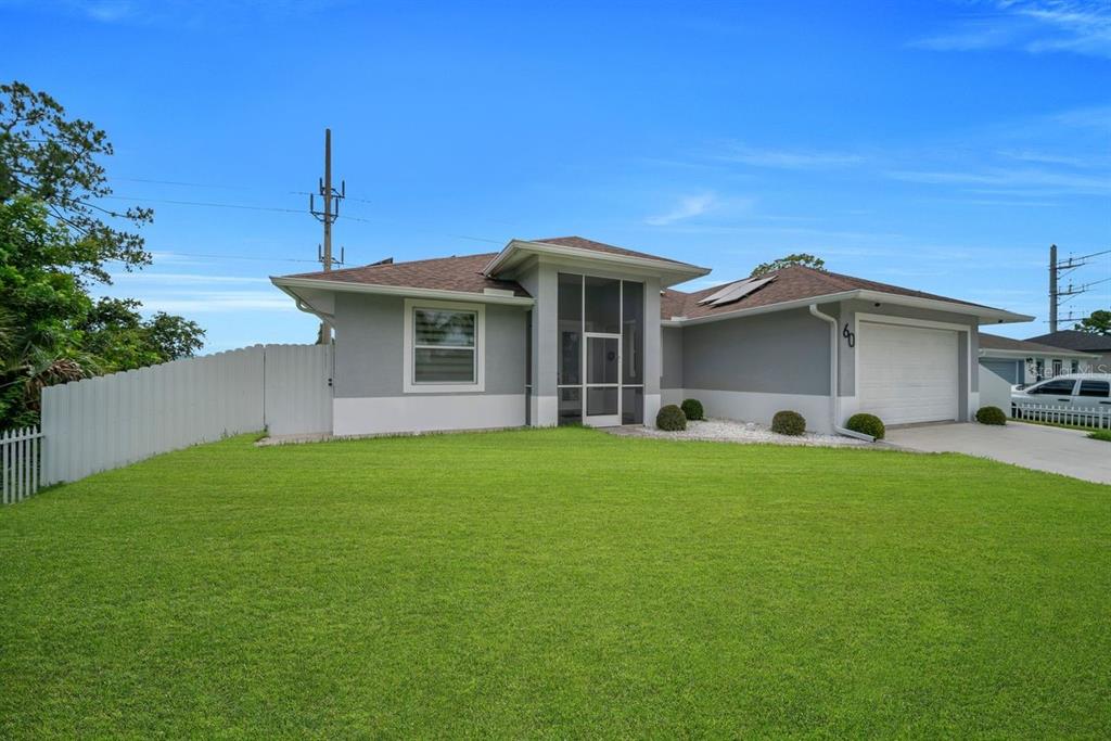 A single-story gray house with a screened entryway, a two-car garage, and a large lawn — 60 FLOYD AVENUE S, LEHIGH ACRES, FL