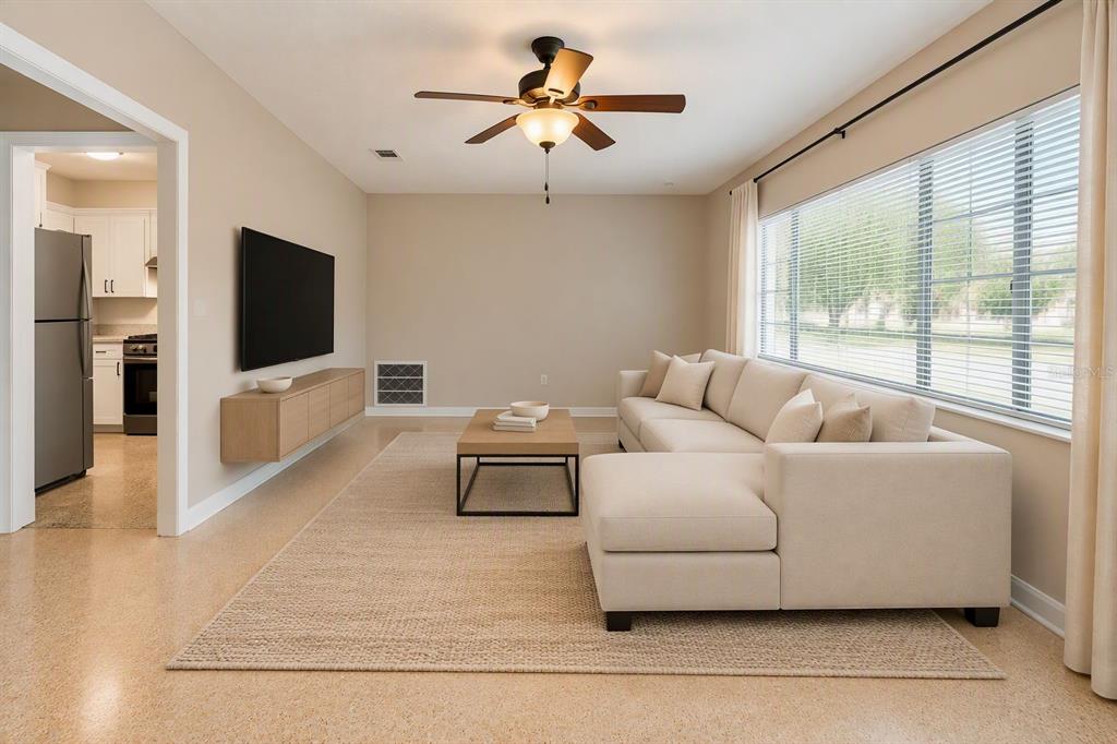An empty room with beige walls, a ceiling fan, and large windows with horizontal blinds — 206 S WESTSHORE BOULEVARD, TAMPA, FL