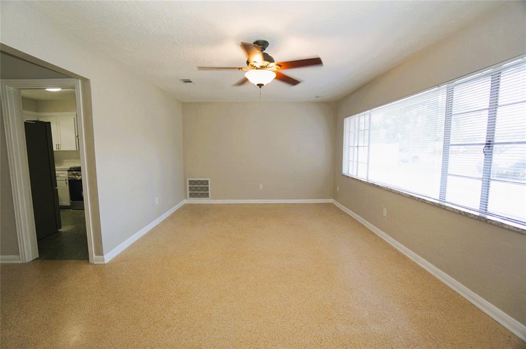 An empty room with light-colored walls, a ceiling fan, and speckled flooring — 206 S WESTSHORE BOULEVARD, TAMPA, FL
