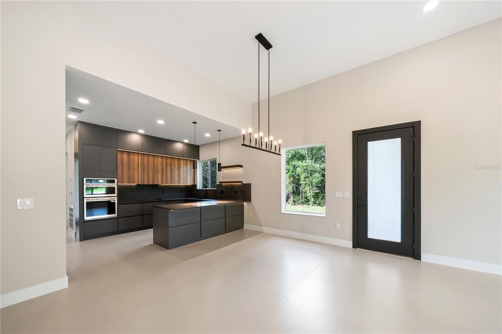 An aerial view shows two modern houses situated on large, wooded residential lots — 12352 SW 61ST PLACE ROAD, OCALA, FL