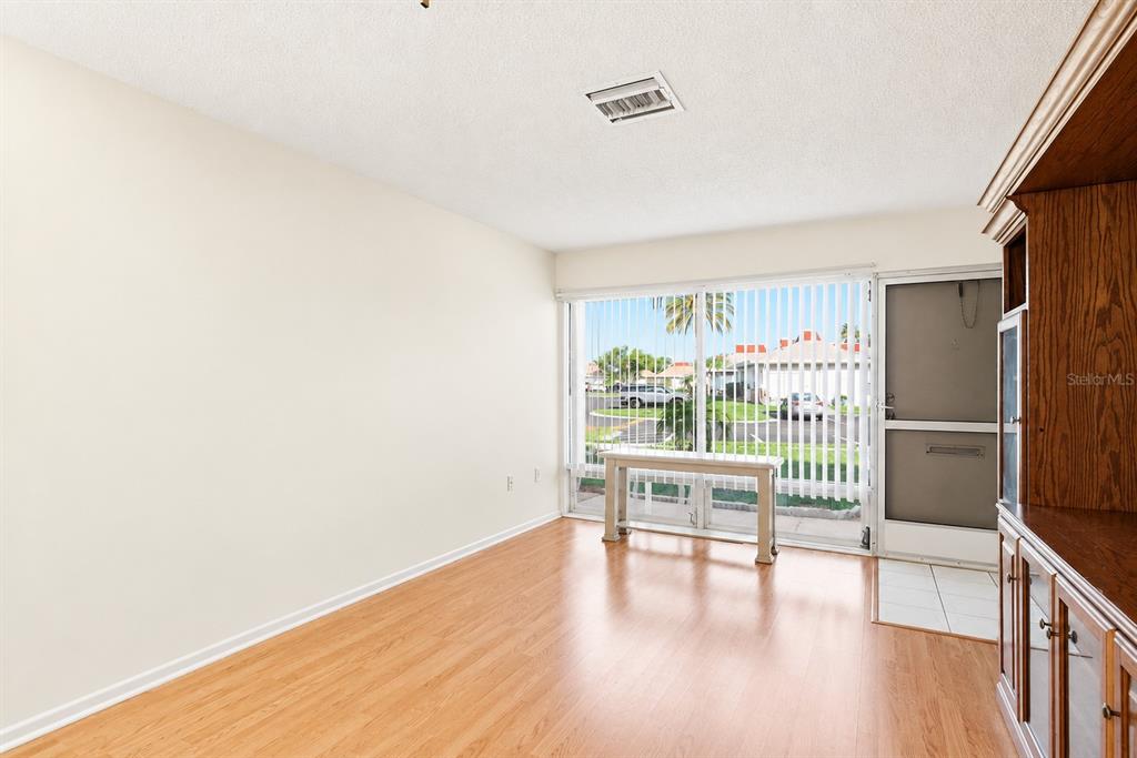 A row of single-story attached homes with tan walls, light-colored roofs, and small front lawns — 4344 TAHITIAN GARDENS CIRCLE UNIT B, HOLIDAY, FL