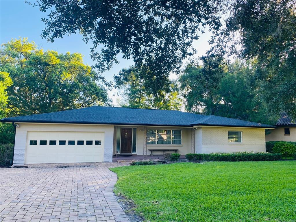 A single-story house with a brick exterior, a garage, and a paved driveway — 1113 VIA DEL MAR, WINTER PARK, FL
