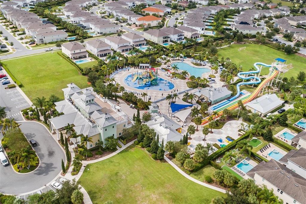 An aerial view shows a community clubhouse with a water park, slides, and surrounding houses — 416 SOUTHFIELD STREET, KISSIMMEE, FL