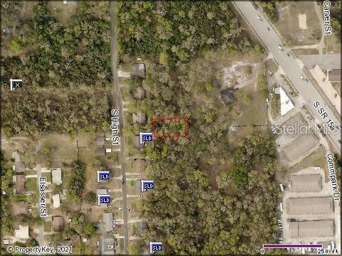 An aerial map view shows a rectangular plot of land highlighted in red near roads — NO STREET, DELAND, FL