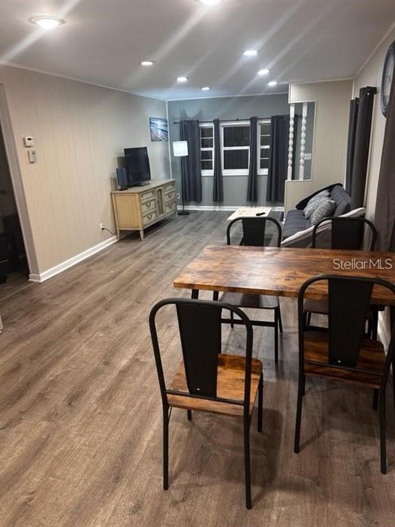 A dining area with a wooden table and chairs opens into a living room space — 530 SUN UP STREET, NORTH FORT MYERS, FL
