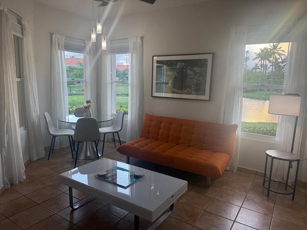 A living and dining area features an orange futon, white coffee table, and tile flooring — 170 Candelero Dr, PALMAS DEL MAR, LAS PALMAS DORADAS, HUMACAO, PR