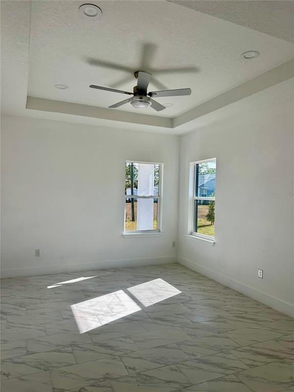 An aerial view shows a single-story house with a dark shingled roof and white exterior — 3135 LOWRY BOULEVARD SE, PALM BAY, FL