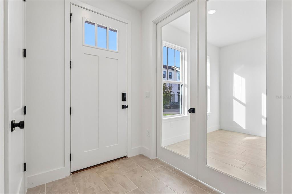 A home office features a wooden desk, a gray chair, and blue vertical wall paneling — 15075 GROVESIDE ROAD, WINTER GARDEN, FL