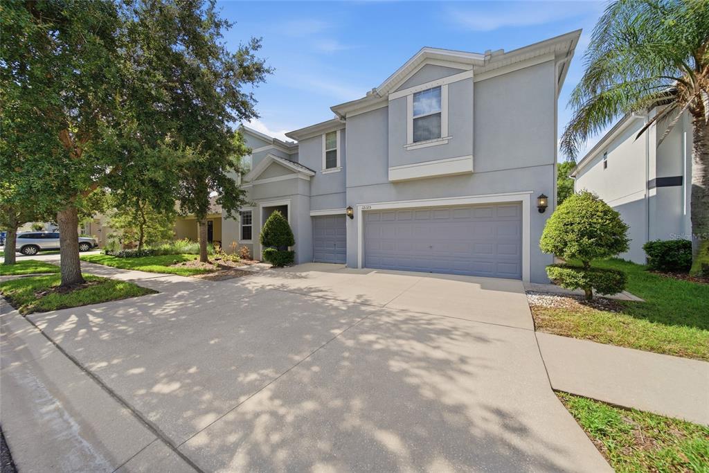 A two-story gray house with a three-car garage and a concrete driveway — 12125 STREAMBED DRIVE, RIVERVIEW, FL