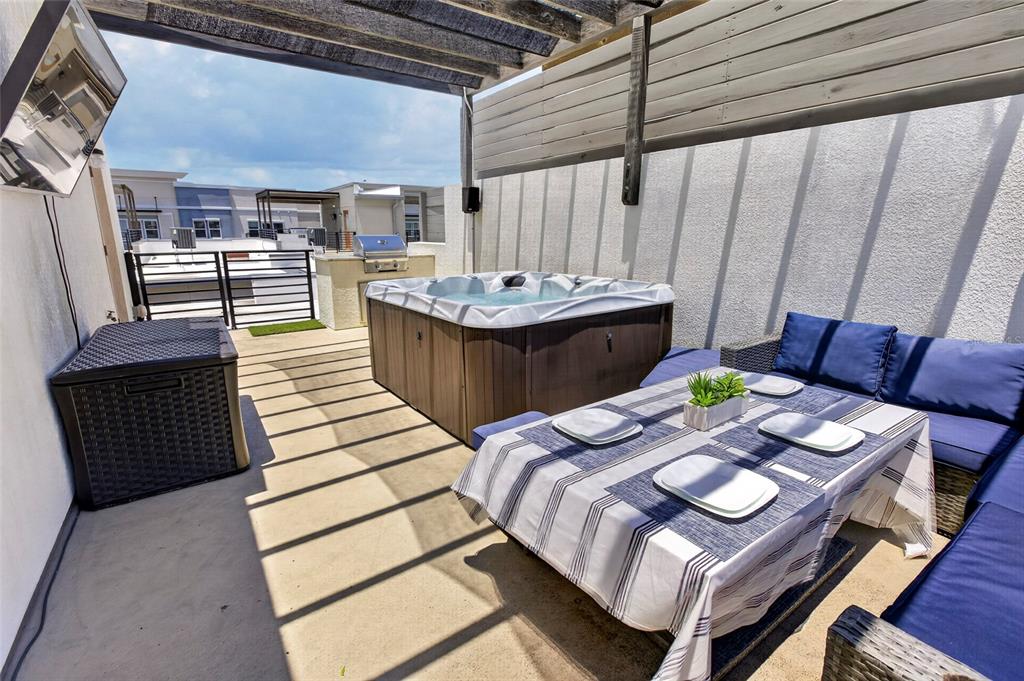 A hot tub with a partially open cover sits on an outdoor rooftop deck — 2511 N GRADY AVENUE UNIT 78, TAMPA, FL