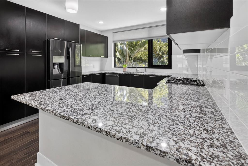 A rooftop terrace features a built-in grill station, metal railings, and a small patch of turf — 2511 N GRADY AVENUE UNIT 78, TAMPA, FL