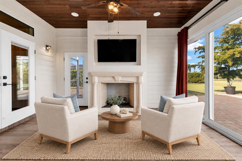 A gray detached garage with a metal roof and double doors sits on a paved lot — 8306 SW SAND CRANE LOT 87 CIRCLE, ARCADIA, FL