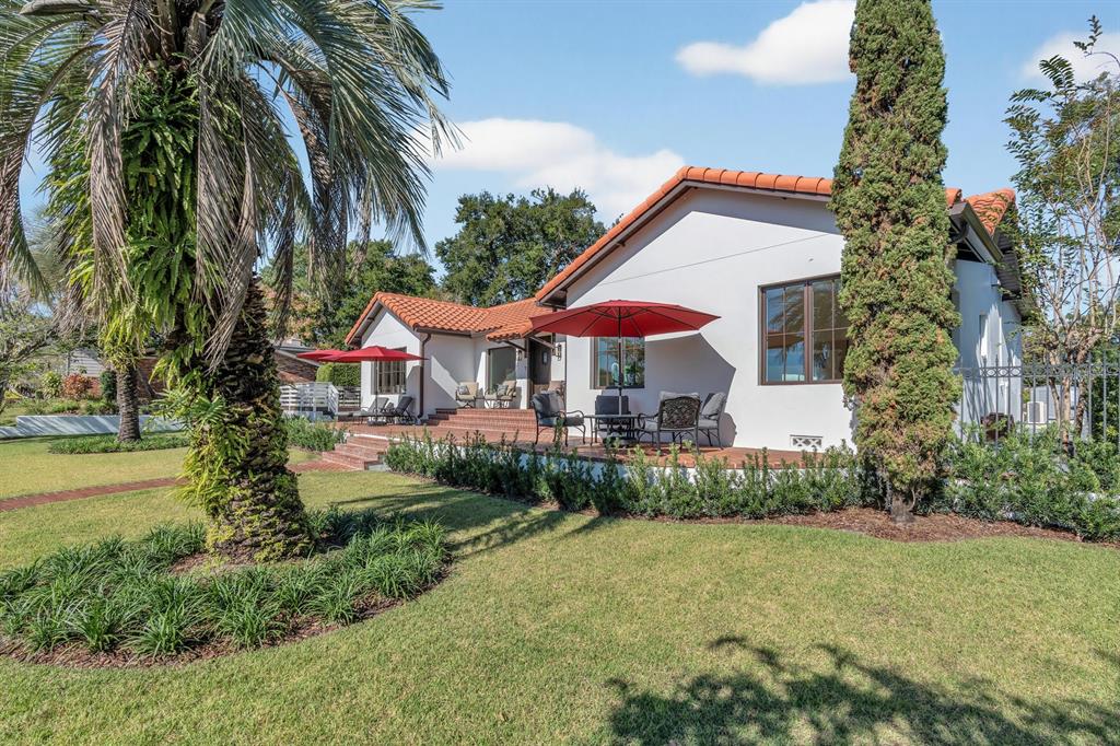 A red brick patio with steps leads to a white house with a tile roof — 631 LAKE CATHERINE DRIVE, MAITLAND, FL